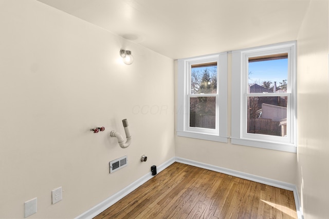 laundry area featuring hookup for a gas dryer and hardwood / wood-style flooring