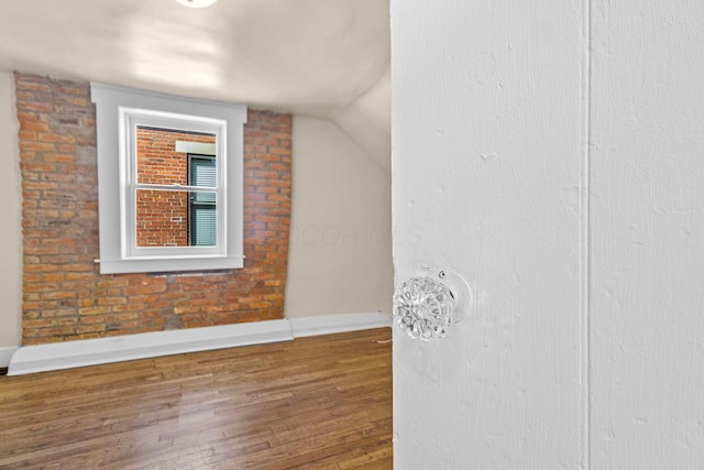 interior space featuring lofted ceiling and wood-type flooring