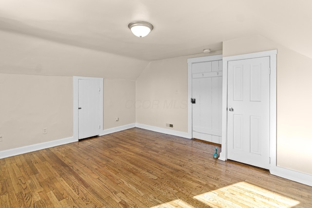 bonus room featuring lofted ceiling and hardwood / wood-style floors