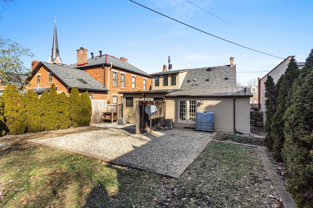 rear view of property featuring central AC and a patio area