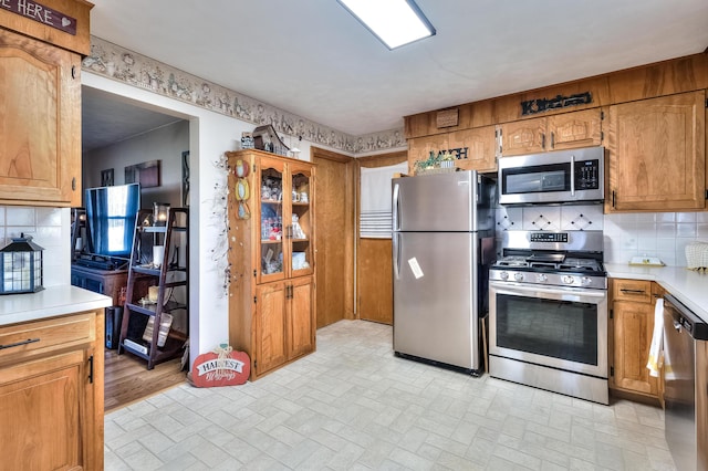 kitchen featuring stainless steel appliances and decorative backsplash