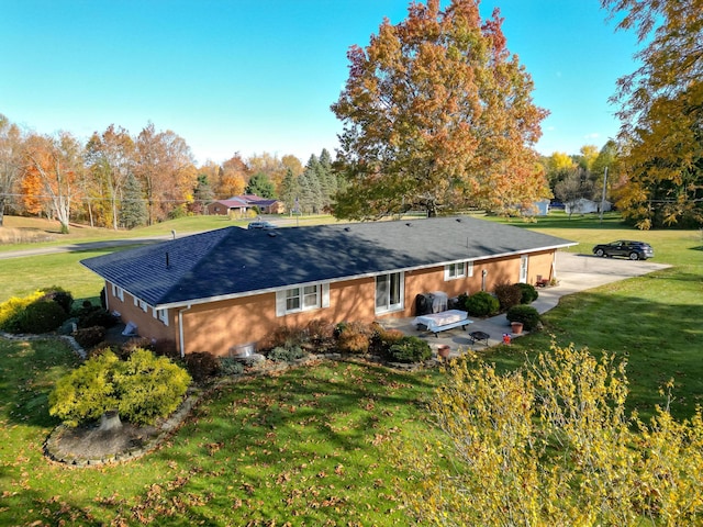 rear view of house with a yard and a patio