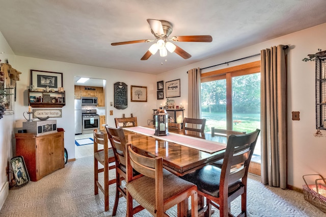 dining room featuring ceiling fan and light colored carpet