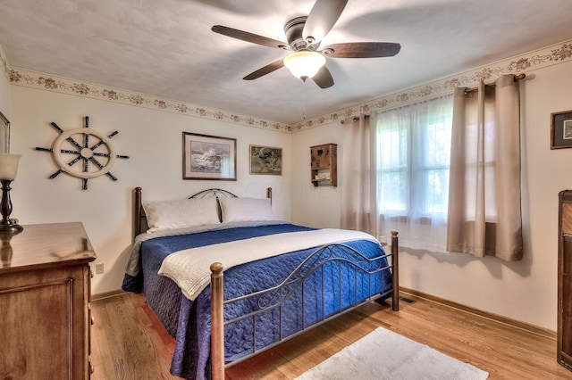 bedroom featuring hardwood / wood-style flooring and ceiling fan