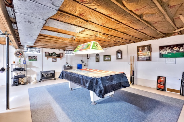 recreation room featuring a wood stove, pool table, and concrete floors