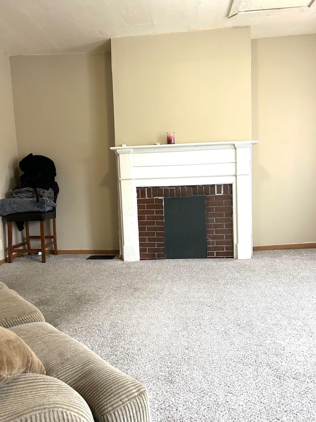 living room featuring a fireplace and carpet floors