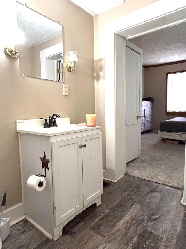 bathroom featuring vanity, hardwood / wood-style floors, and a textured ceiling