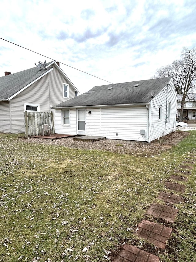 back of property featuring a yard