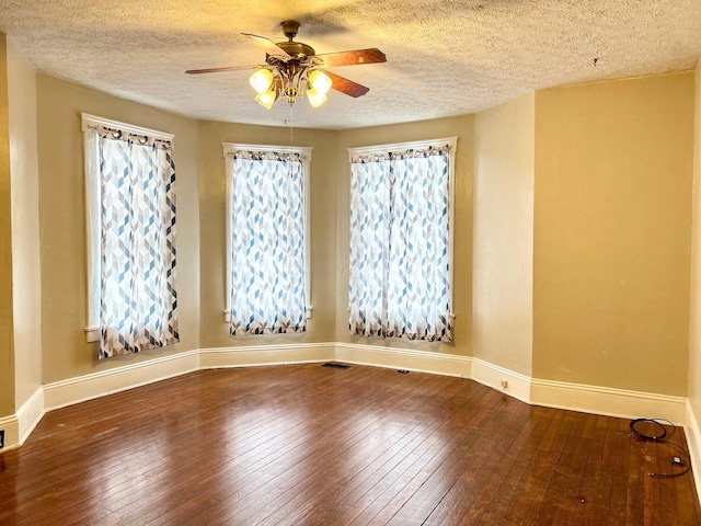 spare room featuring hardwood / wood-style floors, a textured ceiling, and ceiling fan