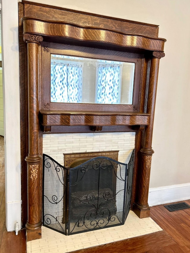 interior details featuring wood-type flooring and a fireplace