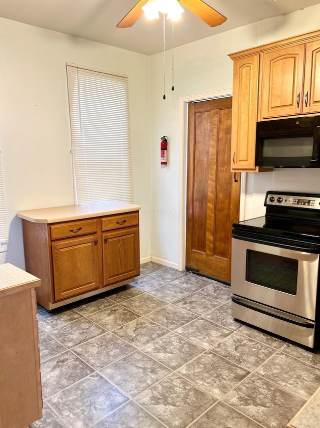 kitchen with ceiling fan and stainless steel electric range