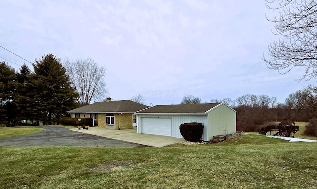 ranch-style home with a garage and a front yard