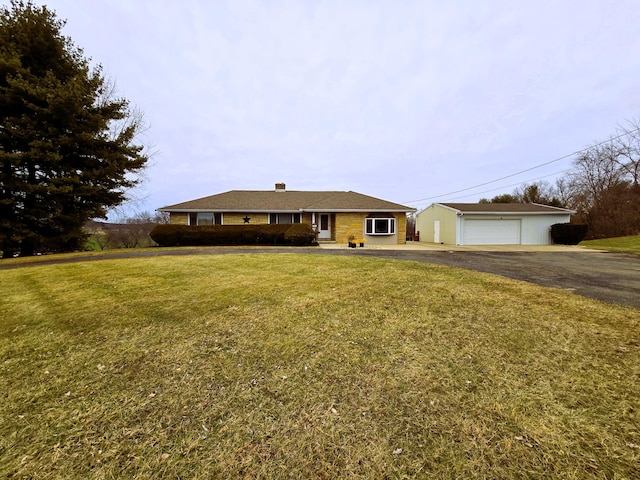 single story home featuring a garage and a front lawn