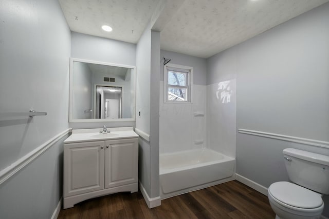 full bathroom with wood-type flooring, toilet, shower / washtub combination, and vanity