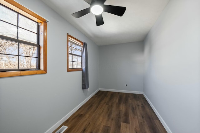 spare room with dark hardwood / wood-style floors and ceiling fan