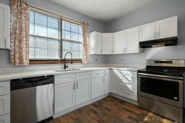 kitchen featuring white cabinetry, sink, and appliances with stainless steel finishes