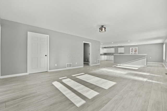 unfurnished living room featuring light wood-type flooring