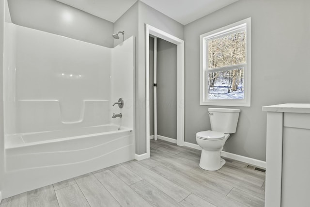 full bathroom featuring vanity, tub / shower combination, and toilet