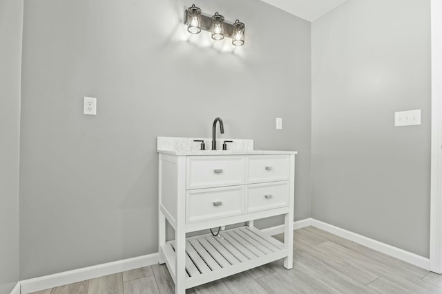 bathroom featuring hardwood / wood-style flooring and vanity