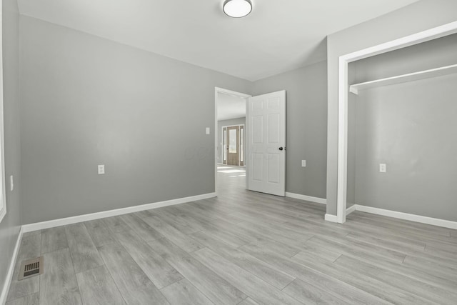 unfurnished bedroom featuring light wood-type flooring