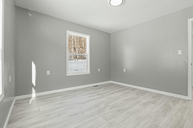 spare room featuring light hardwood / wood-style flooring