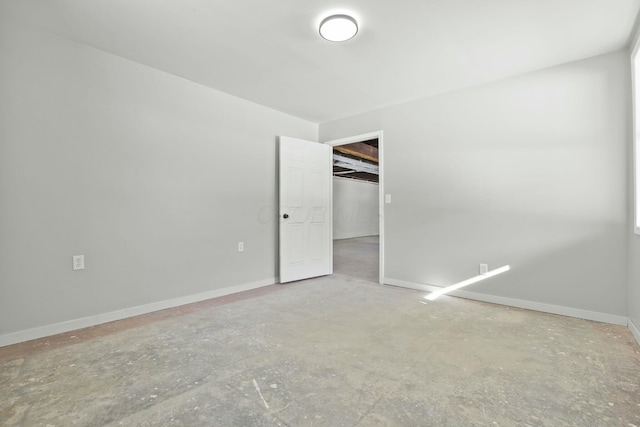 unfurnished bedroom featuring concrete flooring