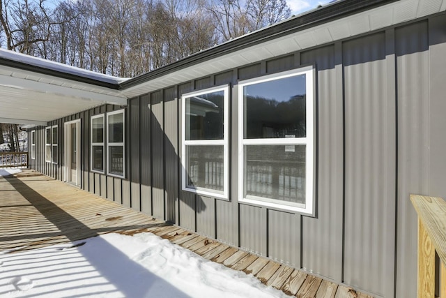 snow covered property with a deck