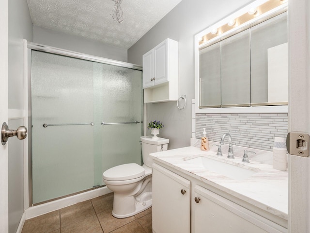 bathroom with tile patterned flooring, backsplash, a shower with door, and toilet