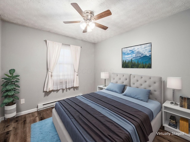 bedroom with ceiling fan, dark hardwood / wood-style floors, and a textured ceiling