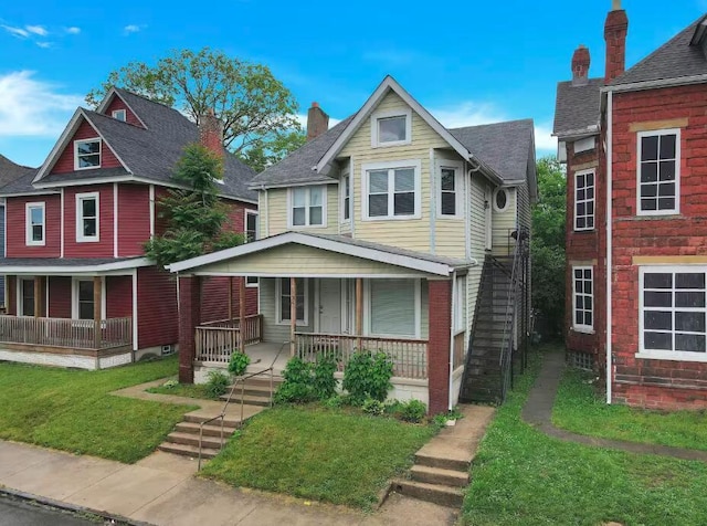 view of front of home featuring covered porch and a front lawn