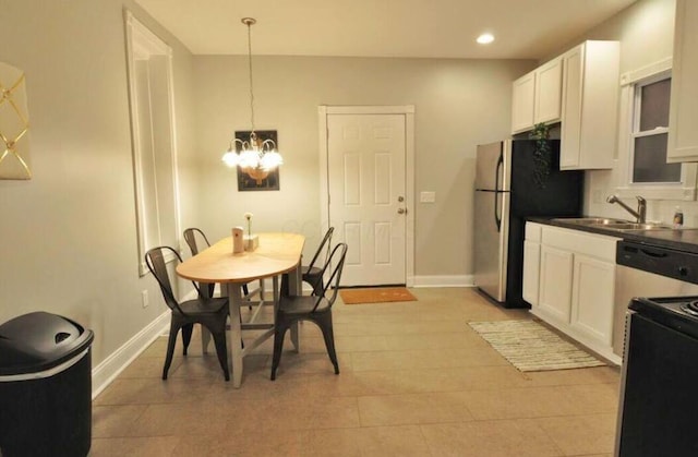 dining space with sink and a chandelier