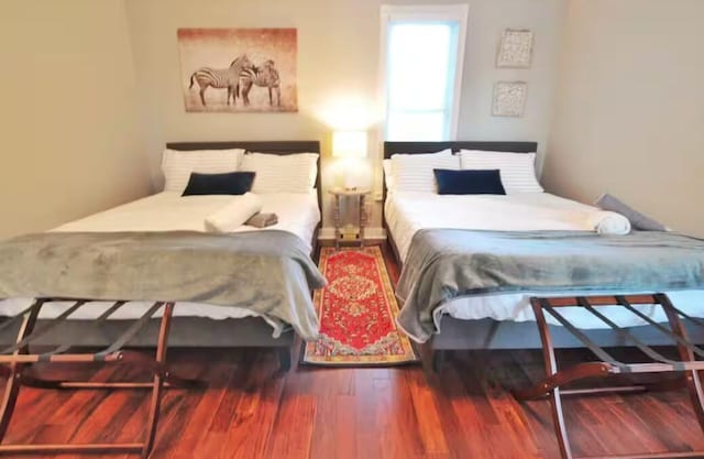 bedroom with wood-type flooring