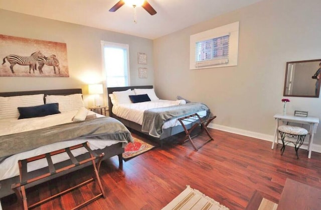 bedroom with dark hardwood / wood-style flooring and ceiling fan