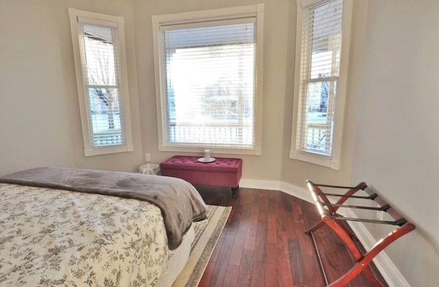 bedroom with dark wood-type flooring