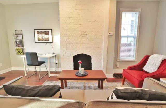 sitting room featuring hardwood / wood-style floors and a fireplace