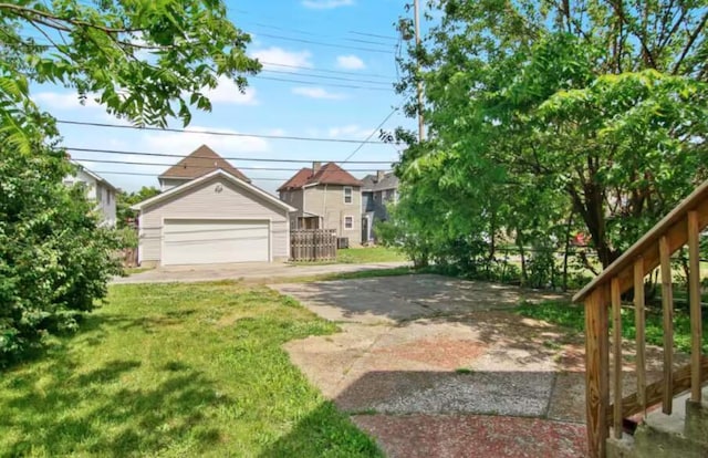 view of front of property with a garage, an outdoor structure, and a front yard