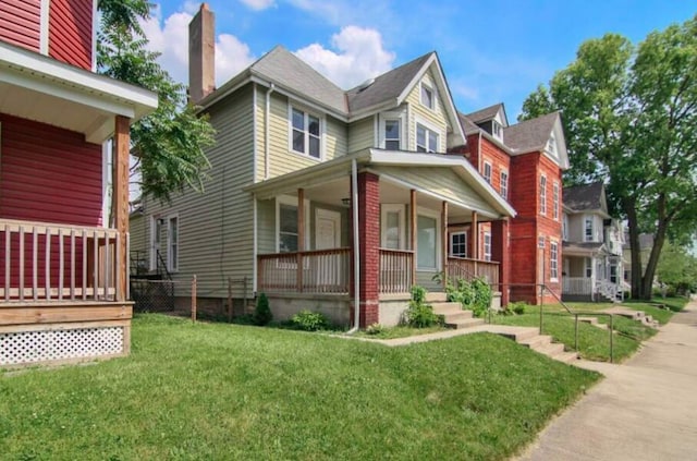 view of front of house featuring covered porch and a front yard