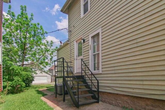 view of home's exterior with cooling unit and a garage