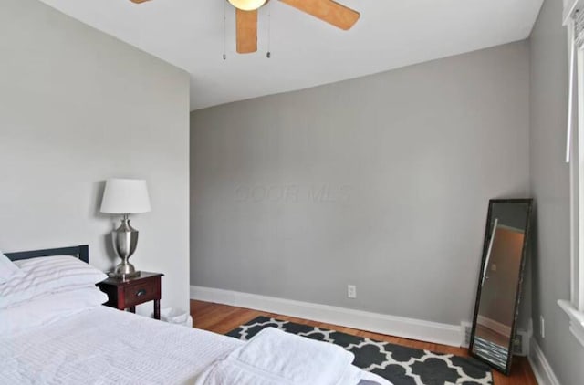 bedroom featuring ceiling fan and dark hardwood / wood-style flooring