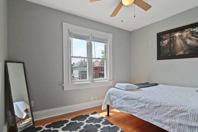 bedroom with hardwood / wood-style floors and ceiling fan