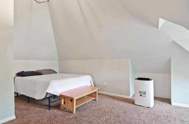 carpeted bedroom featuring lofted ceiling