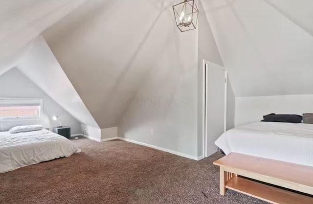 carpeted bedroom with vaulted ceiling and a chandelier