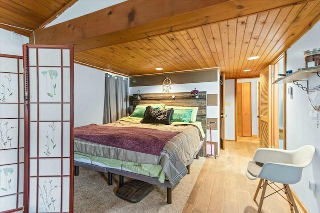 bedroom with lofted ceiling, light wood-type flooring, and wooden ceiling