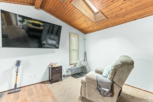 sitting room featuring wood ceiling and vaulted ceiling with skylight