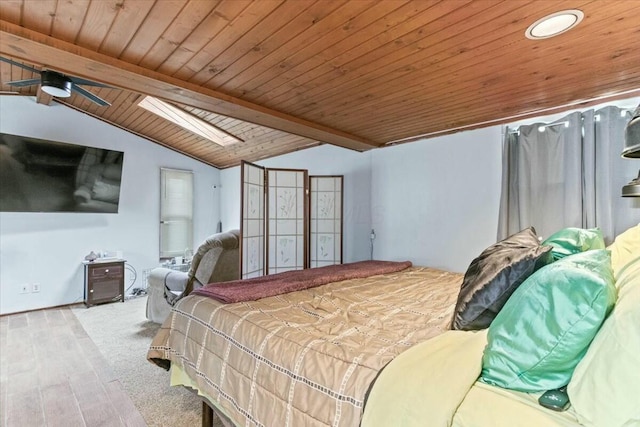 bedroom featuring light colored carpet, lofted ceiling with skylight, and wooden ceiling