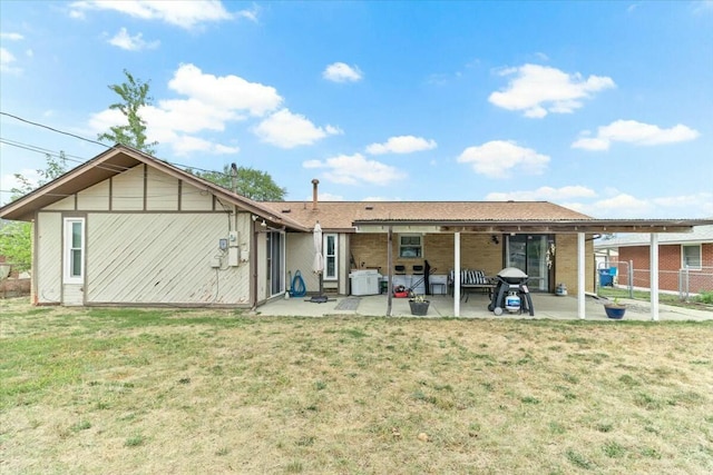 rear view of house with a yard and a patio area