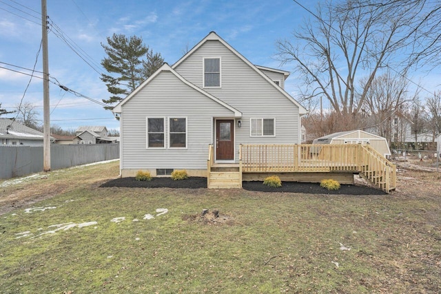 view of front of property featuring a front lawn and a deck