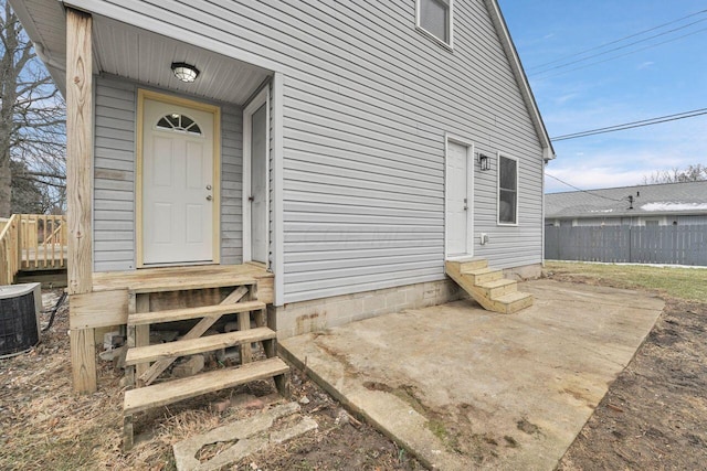 entrance to property with central AC unit and a patio