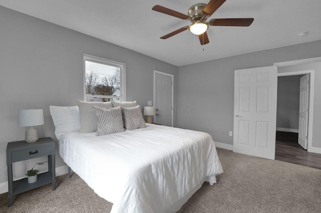 bedroom featuring ceiling fan and dark carpet