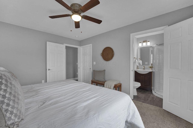 bedroom featuring ceiling fan, sink, and ensuite bath